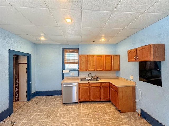 kitchen with sink, a paneled ceiling, and stainless steel dishwasher