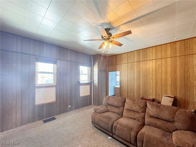 living room with ceiling fan and carpet