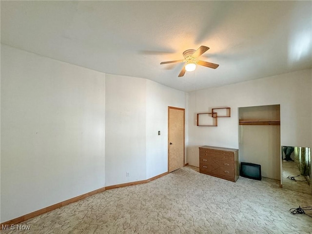 unfurnished bedroom with ceiling fan and light colored carpet