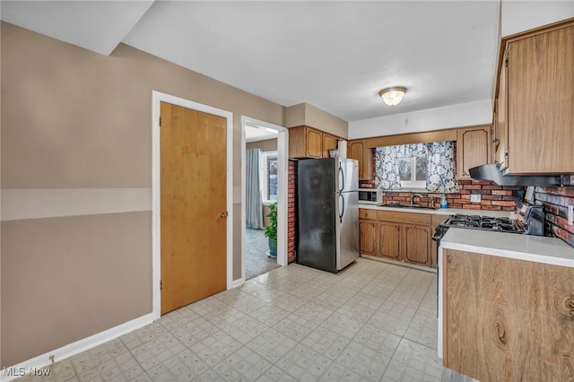 kitchen featuring sink, tasteful backsplash, and appliances with stainless steel finishes