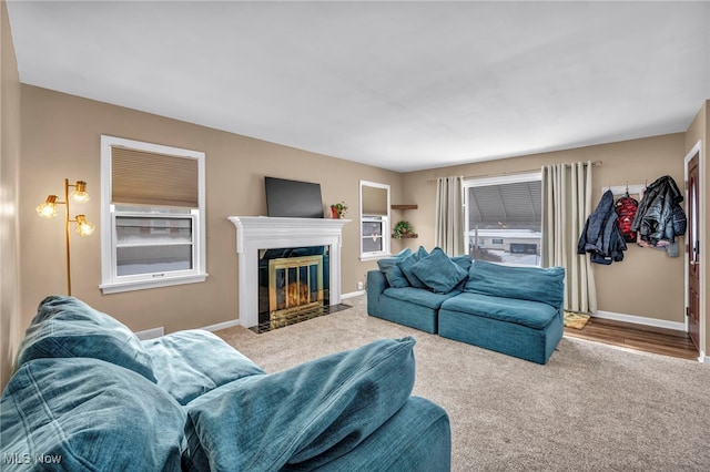 carpeted living room with a fireplace