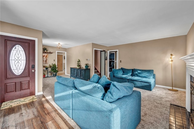 living room featuring a fireplace and carpet floors