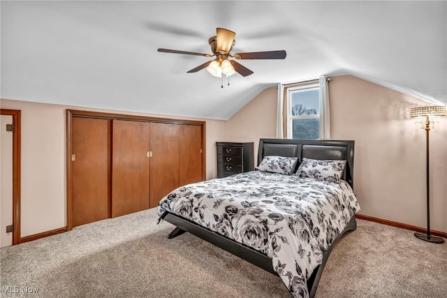 bedroom with ceiling fan, light colored carpet, a closet, and lofted ceiling