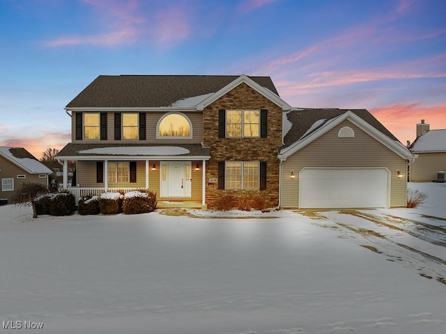 view of front of home featuring a porch and a garage