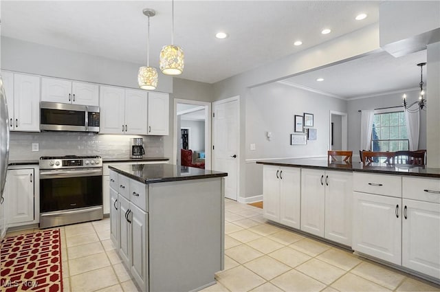 kitchen featuring a kitchen island, tasteful backsplash, white cabinetry, and appliances with stainless steel finishes