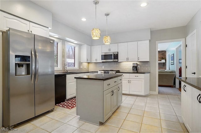 kitchen with white cabinets, sink, appliances with stainless steel finishes, and pendant lighting