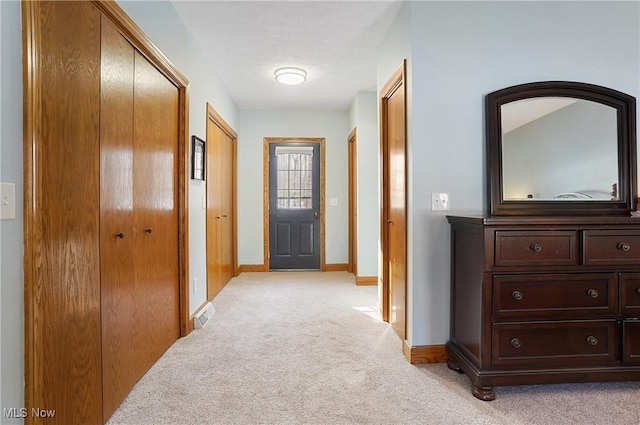 hallway with light colored carpet