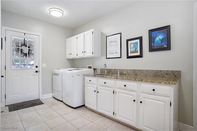 laundry room with sink, light tile patterned floors, cabinets, and washer hookup