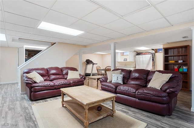 living room featuring hardwood / wood-style flooring and a drop ceiling