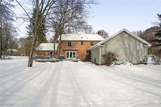 snow covered house with a deck