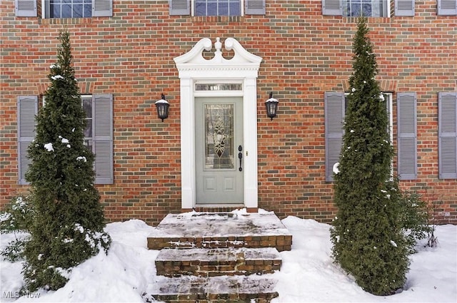 view of snow covered property entrance