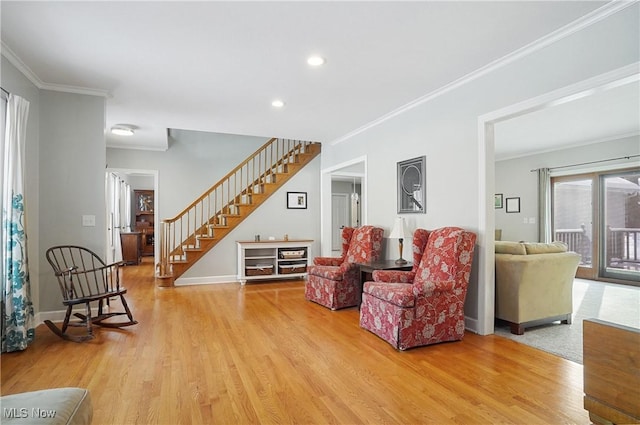 living room with crown molding and light wood-type flooring