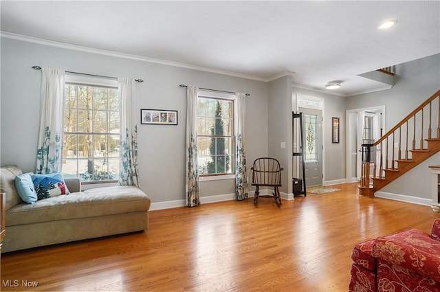 interior space with light hardwood / wood-style flooring, crown molding, and plenty of natural light