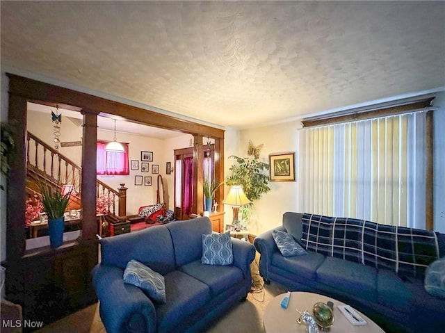 living room with a textured ceiling and carpet