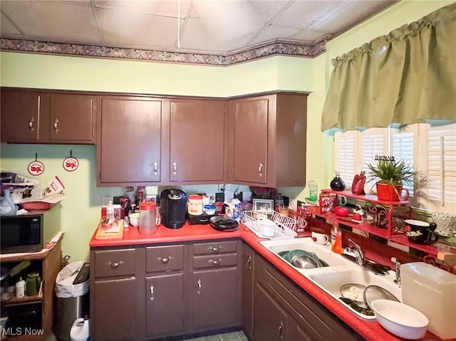 kitchen with sink and a paneled ceiling