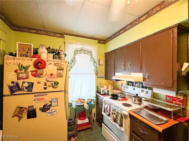 kitchen featuring electric stove and refrigerator