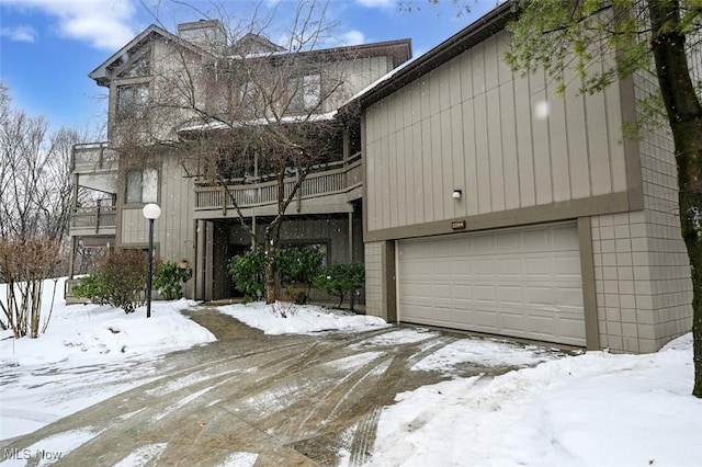 view of front of property featuring a balcony and a garage