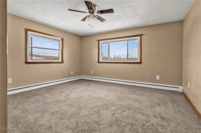 spare room featuring ceiling fan, a baseboard radiator, and carpet flooring