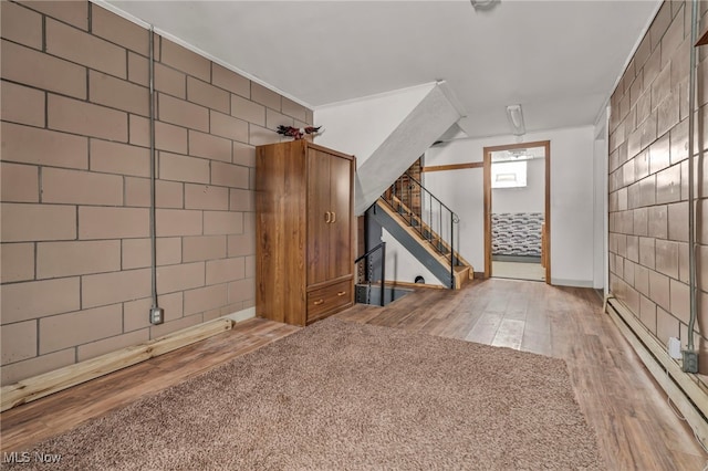 interior space featuring wood-type flooring and a baseboard heating unit