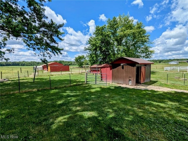 view of yard with an outbuilding and a rural view