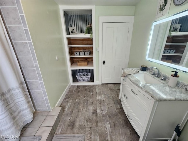 bathroom featuring vanity and wood-type flooring