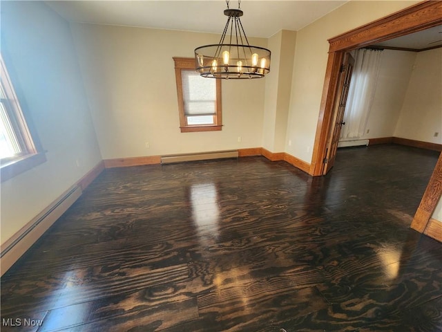 empty room featuring baseboard heating and a chandelier