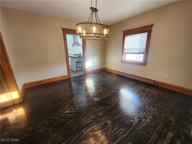 spare room with a baseboard radiator, a chandelier, and dark hardwood / wood-style flooring