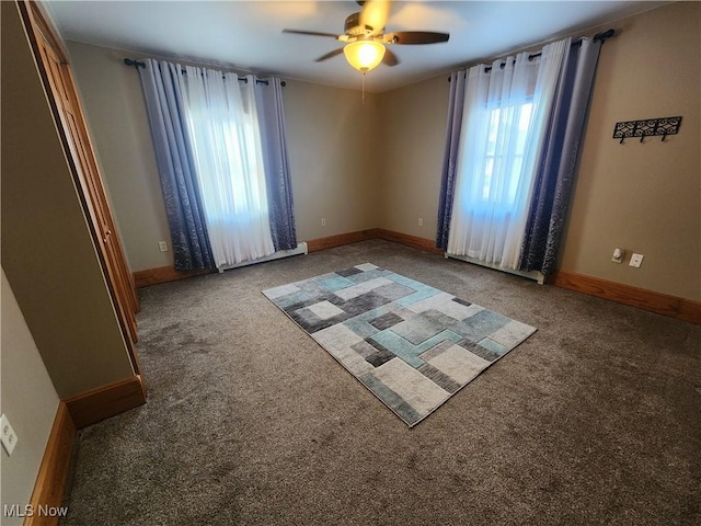 carpeted empty room featuring ceiling fan