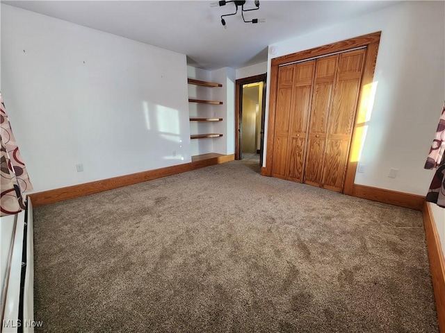 unfurnished bedroom with carpet floors and a closet