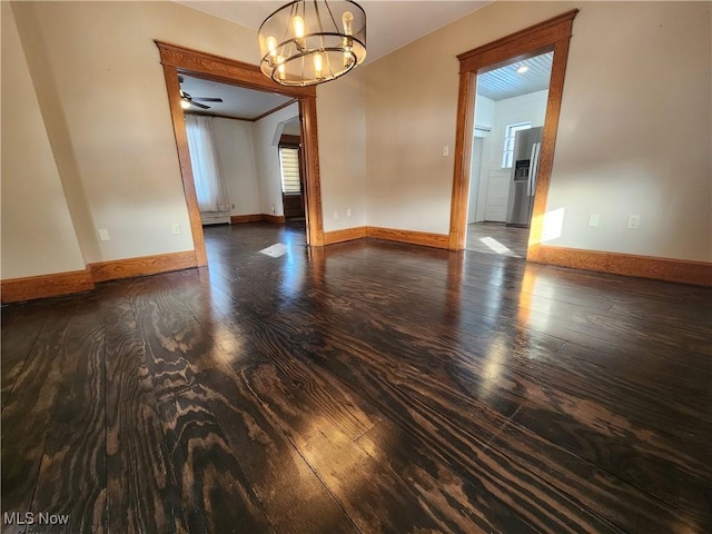 unfurnished room featuring dark hardwood / wood-style floors and a chandelier