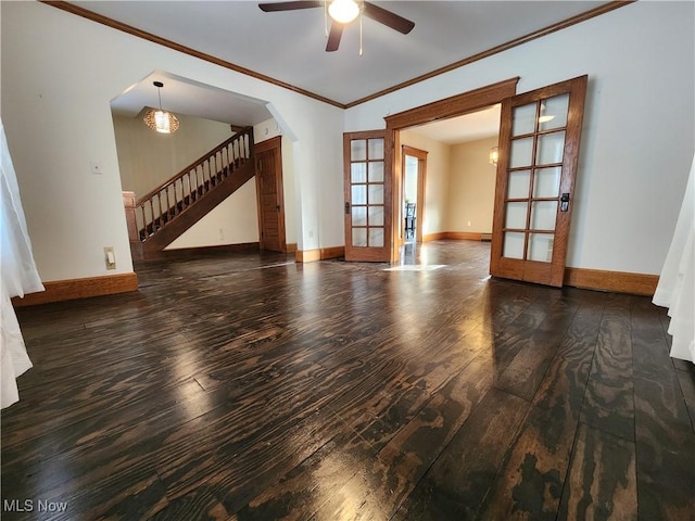 unfurnished room featuring ceiling fan, dark wood-type flooring, crown molding, and french doors