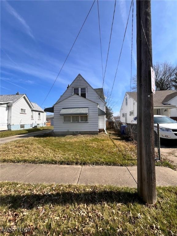 view of side of home with a yard