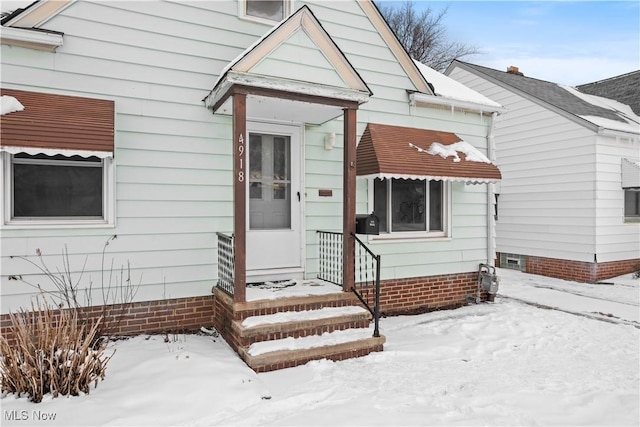 view of snow covered property entrance