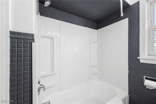 bathroom with  shower combination and tile walls