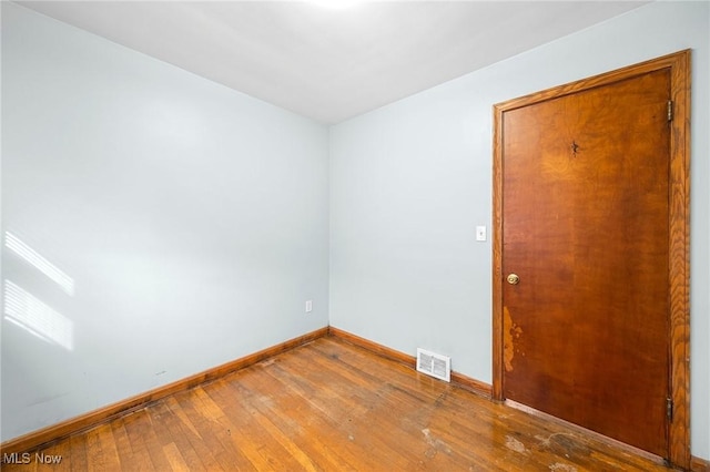 unfurnished room with wood-type flooring