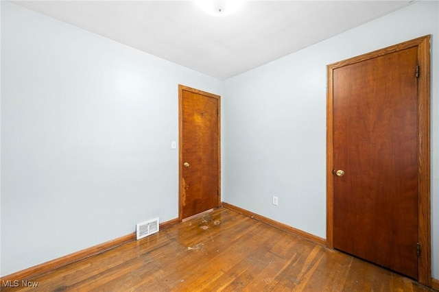 unfurnished room with hardwood / wood-style floors