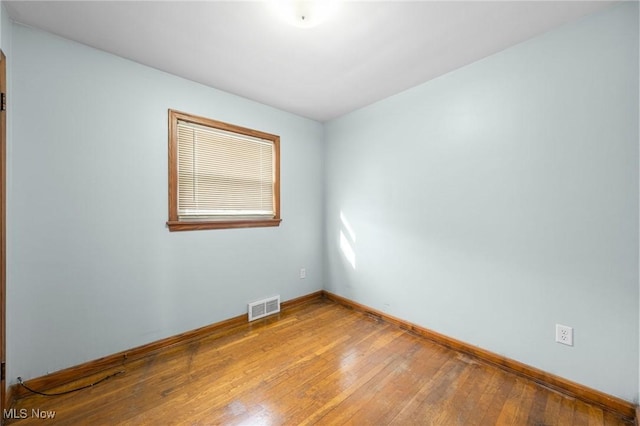 spare room with hardwood / wood-style floors