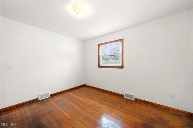 spare room featuring hardwood / wood-style floors