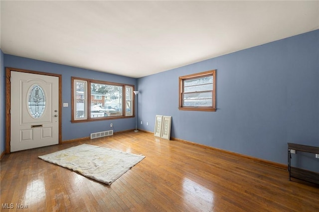 foyer entrance featuring a wealth of natural light and hardwood / wood-style floors