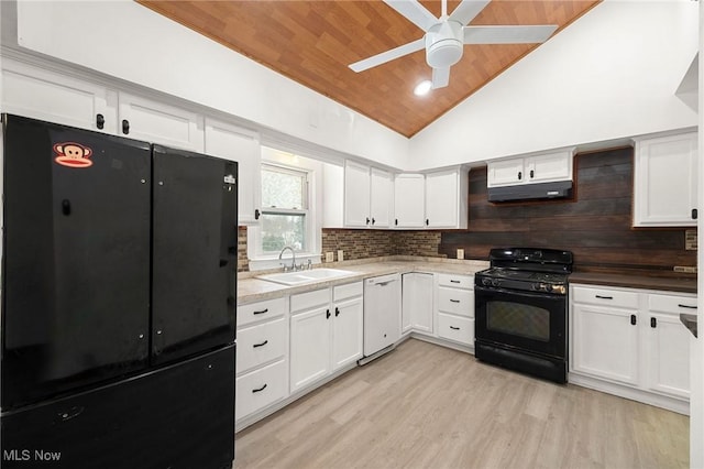 kitchen featuring sink, black appliances, and white cabinetry