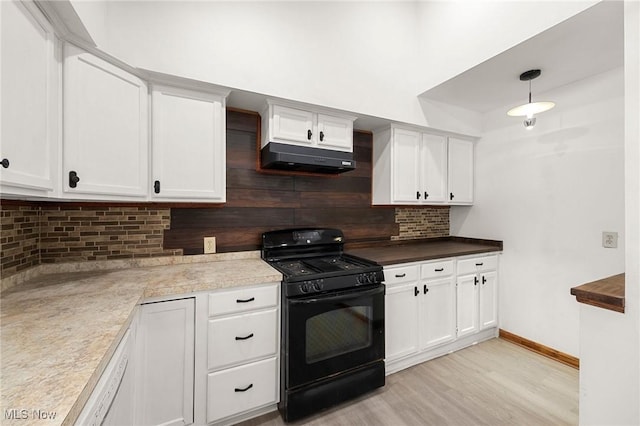 kitchen with light hardwood / wood-style flooring, hanging light fixtures, white cabinets, tasteful backsplash, and black range with gas cooktop