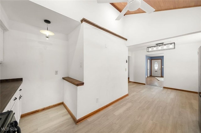 corridor with wood ceiling and light hardwood / wood-style flooring