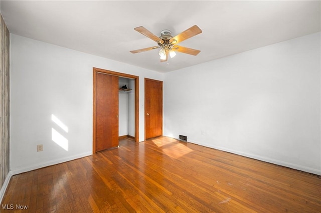 empty room with hardwood / wood-style flooring and ceiling fan