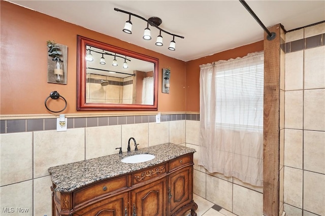 bathroom featuring walk in shower, tile walls, tile patterned floors, and vanity