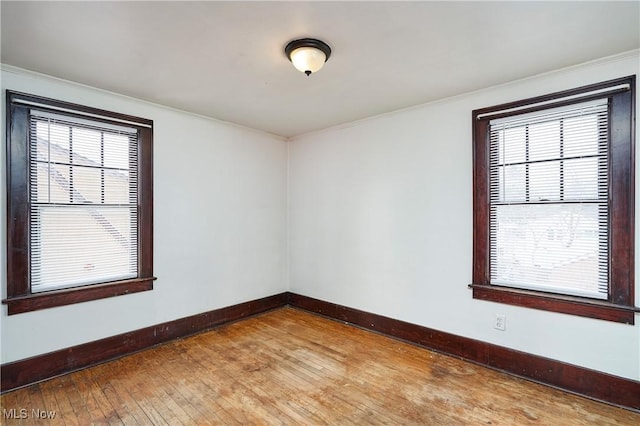 empty room with hardwood / wood-style floors