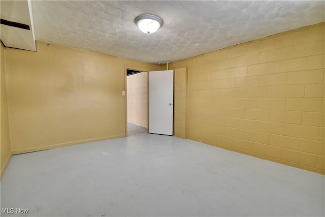 unfurnished room with a textured ceiling