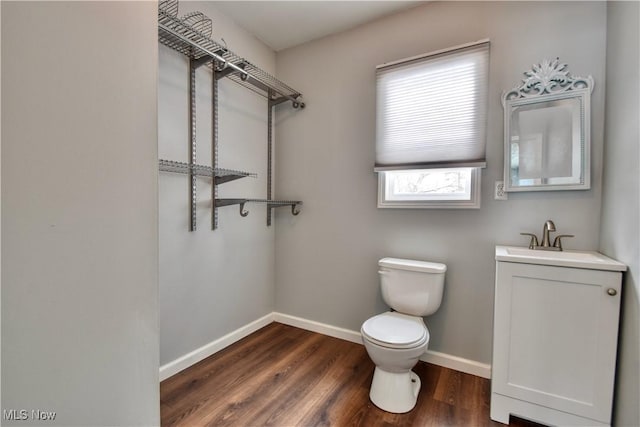 bathroom featuring hardwood / wood-style flooring, toilet, and vanity