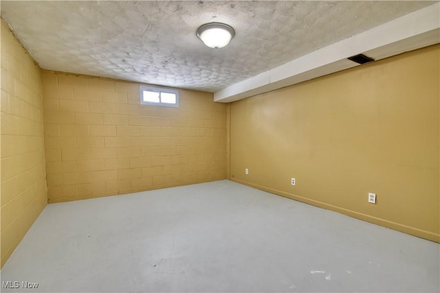 basement featuring a textured ceiling