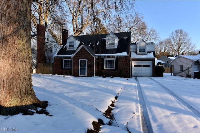 new england style home featuring a garage