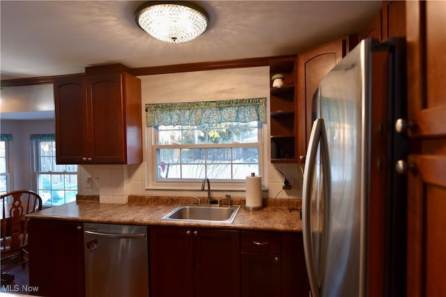 kitchen featuring sink, plenty of natural light, tasteful backsplash, and appliances with stainless steel finishes